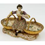 Probably by Derby porcelain twin salt, modelled as a female flower picker flanked by two baskets,