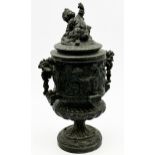 19th century cast pewter lidded urn decorated in relief with the feast of Bacchus, 32cm high