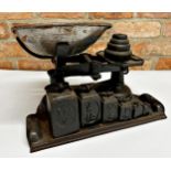 Vintage cast iron counter scales with two sets of graduated weights, 40cm long