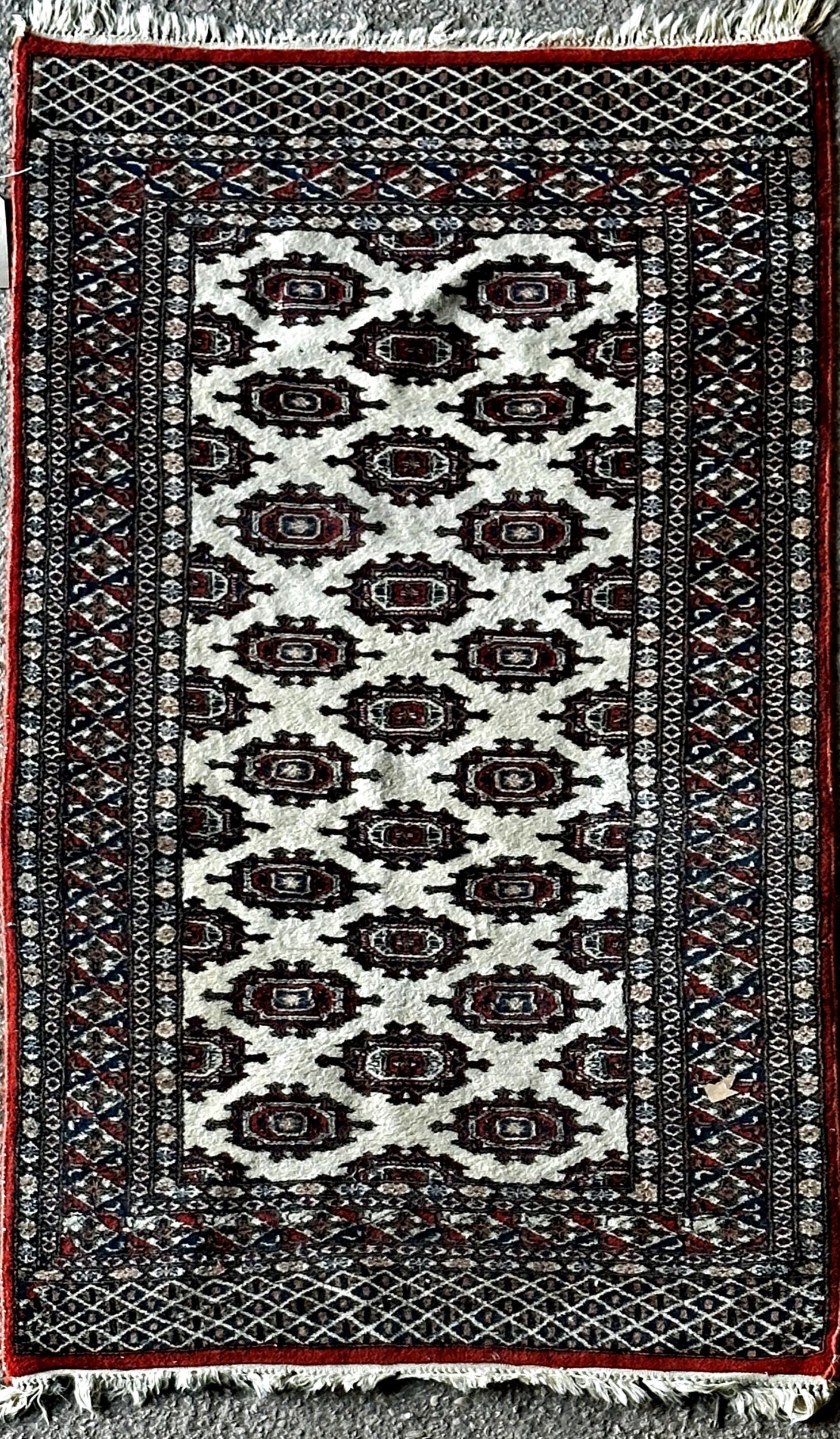 Bokhara rug with typical geometric medallion decoration on a cream ground, 175 x 195cm