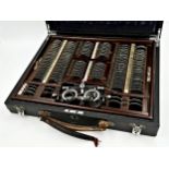Early 20th century opticians lens case, complete fitted interior with various strength lenses with