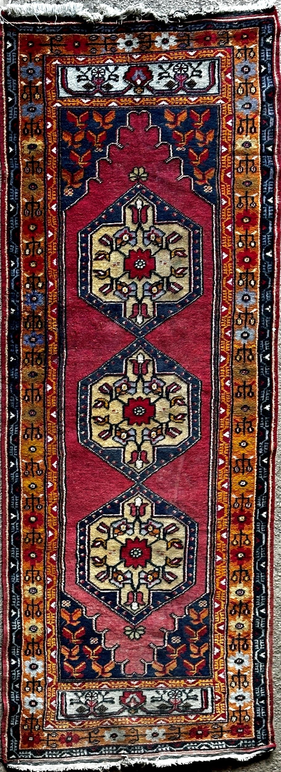 Good full pile Afghan runner with red motifs on a blue ground, 290 x 110cm