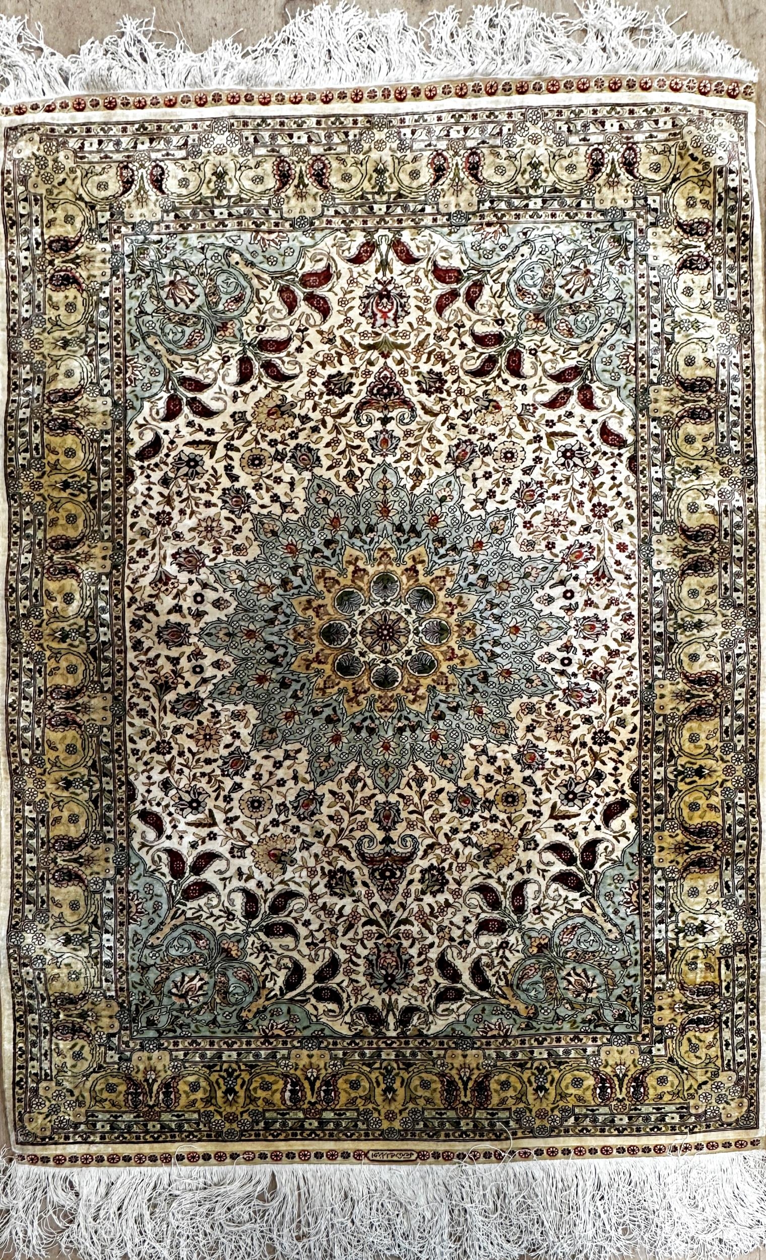 Incredible hand stitched Turkish Hereke silk rug from East Anatolia, with signature, scrolled floral