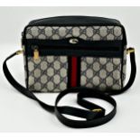 A vintage Gucci monogram GG blue red stripe crossbody bag featuring signature navy Gucci GG print