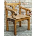 A 19th century Gothic Revival pitch pine carver hall chair