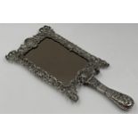 Remarkable late Victorian silver hand / easel mirror, the frame pierced with hinged handle,