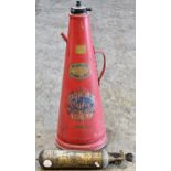 Vintage industrial metal fire extinguisher with red painted finish and rivetted seam together with a