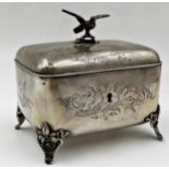Continental Polish silver caddy, mounted by a bird, engraved with scrolled decoration and cast feet,