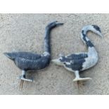 Pair of cast aluminium garden geese with traces of original paint with stakes to the feet, 48cm high