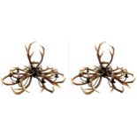 Impressive pair of simulated entwined antler chandeliers, enclosing an eight branch brass light
