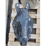 A reconstituted stone hanging wall feature in the form of a horses head with painted finish, 52cm