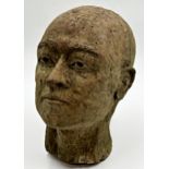 Reconstituted stone sculpture of a man's head in the manner of a death mask, 30cm high.