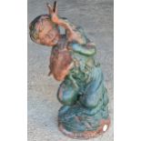 A good cast iron garden water feature of a cherub holding a duck with painted and distressed finish,