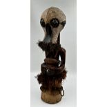 Tribal Interest - Songye power figure from DR Congo, with carved grotesque mask, 60cm high