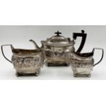 George III silver three piece boat-shaped tea service, with chased and fluted decoration, makers