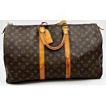 A classic Louis Vuitton Keepall 50 travel bag in brown monogram canvas and leather. Hardware in gilt