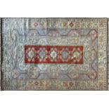 Large Turkish caucasion country house carpet with central red panel with various further pastel