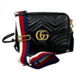 A brand new Gucci GG Marmont flap calfskin black leather handbag featuring a top handle and