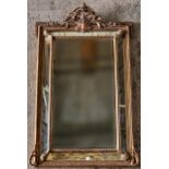 Good giltwood and gesso cushion wall mirror, with pierced scrolled pediment and further beaded,