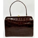 A stunning 1940s brown crocodile skin handbag. Hardware in gilt metal with clasp