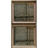 Pair of giltwood and gesso wall mirrors with darted frames with repeating rope twist acanthus