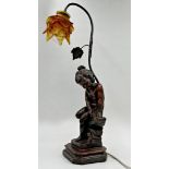 Resin bronze figural Art Nouveau style table lamp modelled with a seated cherub upon a stepped