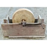 Vintage grinding wheel with iron handle set in a wooden frame 43 x 65cm