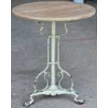 A cast iron table in the style of W.A.S Benson with scrolled supports and lions paw feet, 73 x 61cm