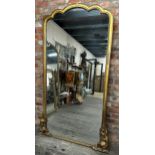 A 19th century Florentine giltwood full length mirror, with shaped original glass plate flanked by