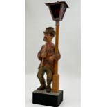 Karl Griesbaum carved wooden whistler or whistling man automaton, under a street lantern, 50cm high,