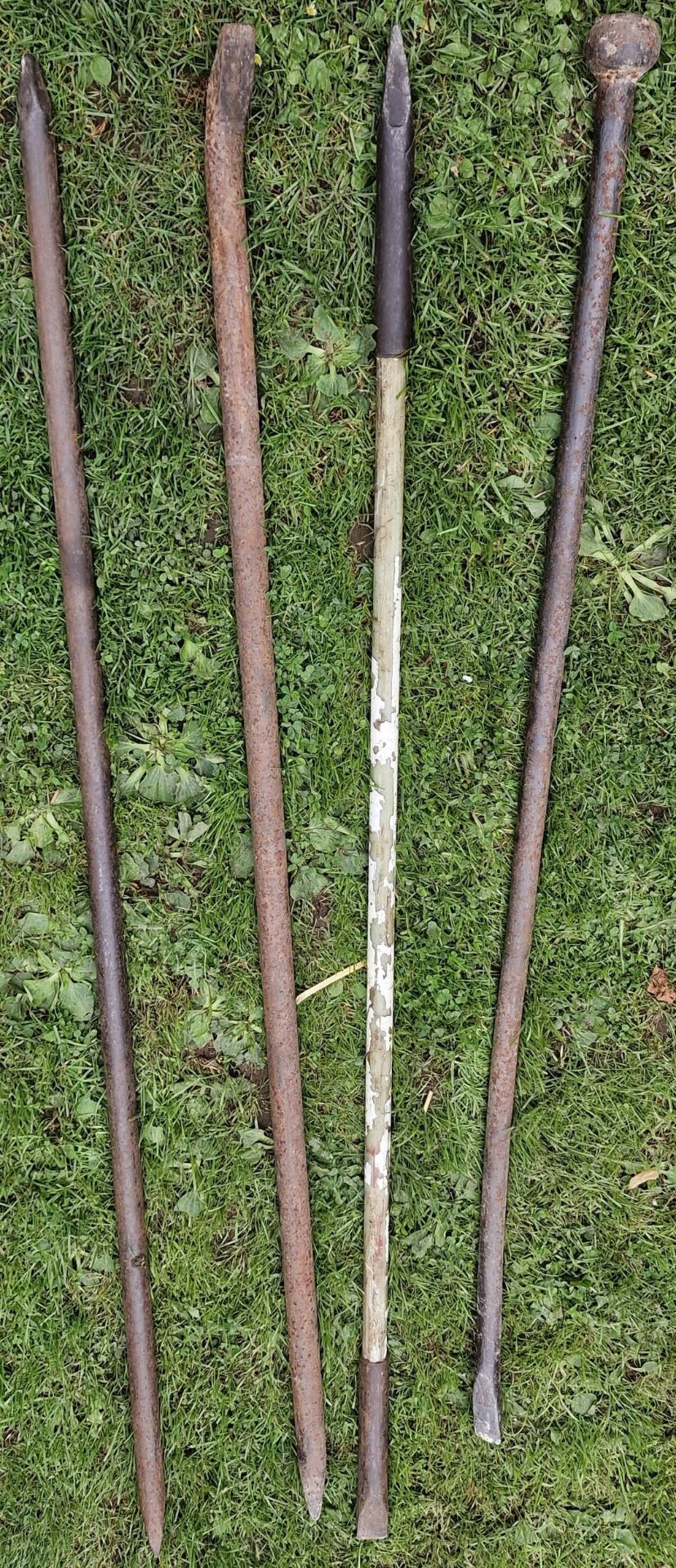 Four vintage iron digging/pry bars together with a vintage iron post thumper (5)