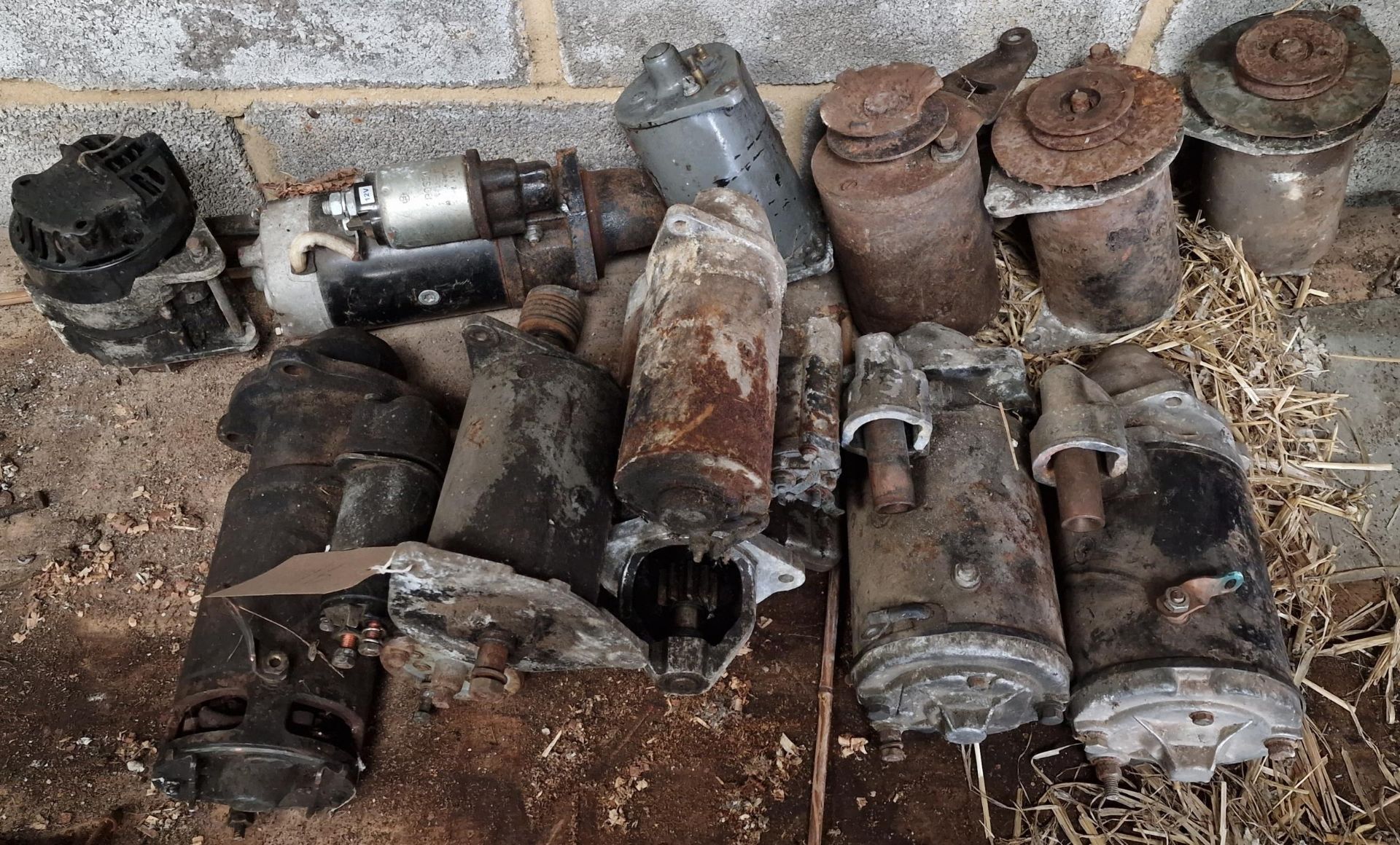 Collection of vintage Massey Ferguson tractor parts containing mainly starting motors