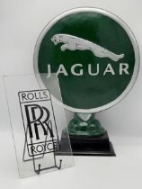 Cast iron Jaguar advertising signage, 52cm high together with a further Rolls Royce Perspex sign (2)