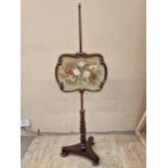 Regency mahogany pole screen, fitted with a floral wool work tapestry panel, 142cm high