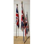 A girl guides stitched Union Jack upon a pole with brass mount together with two further Union Jacks
