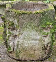 Well weathered octagonal garden planter with inscribed front panel, decorated with various