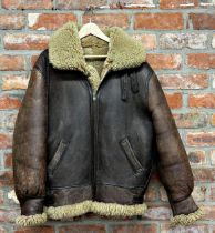Aviator brown leather flight jacket lined in sheepskin. With collar and cuffs, adjustable belted