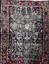 A once magnificent Persian Tree of Life rug on navy blue ground, L117 x W84cm
