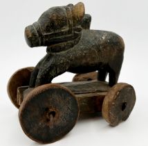 Carved Indian folk art treen Nandi bull on wheels, traces of original paint, 21cm long