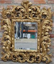 Decorative Florentine gilt wall mirror with central bevelled plate, inscribed 'made in Italy'