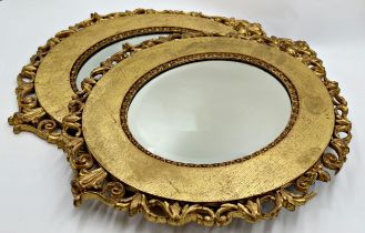 A pair of Antique Florentine style giltwood framed oval wall mirrors with bevelled glass plate, 56cm
