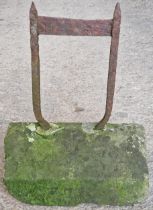 Antique iron boot scraper set in a weathered stone block, 42cm high