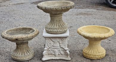 Three reconstituted stone bird baths with fluted socles plus a square pedestal base, 30cm high (4)