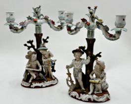Pair of 19th century Dresden porcelain twin branch candelabra, each mounted by playful children,