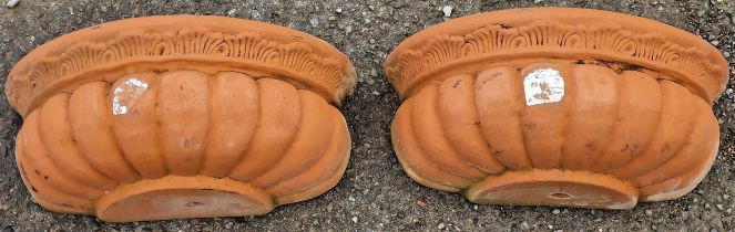 Pair of terracotta wall planters with lobed bowls, 17cm high x 42cm wide