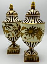 Good quality pair of Wedgwood porcelain lidded urns, with gilt acorn finials and floral band, 26cm