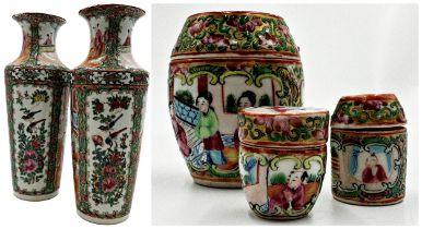 A pair of late 19th century Canton Famille Rose vases, 31cm high, together with three further