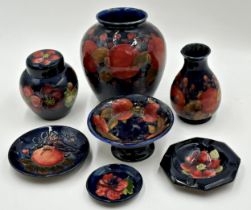Collection of Moorcroft pottery to include pomegranate vase 15cm high, further vase, lidded scent