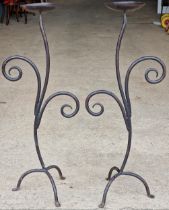 Pair of scrolled wrought iron candlesticks, 119cm high