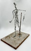 Unusual figural wirework sculpture upon a plinth base, 53cm high.